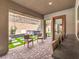 Inviting covered patio featuring patterned pavers, a hot tub, and comfortable seating for relaxing and entertaining guests at 72 Reverie Heights Ave, Henderson, NV 89011