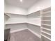 Large walk-in closet offering plenty of storage with shelves and hanging rods at 72 Reverie Heights Ave, Henderson, NV 89011