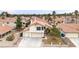 A two-story home showcases a three-car garage and well-manicured landscaping at 7445 Shangri La Ave, Las Vegas, NV 89147