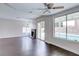 Bright living room with a fireplace, wood floors, and views of the pool through large windows and sliding doors at 7445 Shangri La Ave, Las Vegas, NV 89147