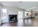 Spacious living room with a fireplace, wood floors, and sliding glass doors to the pool at 7445 Shangri La Ave, Las Vegas, NV 89147