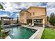Expansive backyard features a pool, spa, outdoor seating, and lush greenery, ideal for relaxation and entertaining at 748 Fast Green Way, Las Vegas, NV 89148