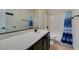 Well-lit bathroom featuring a white vanity top and dark cabinets with a shower and bathtub combo at 748 Fast Green Way, Las Vegas, NV 89148