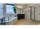 A modern bathroom with double vanity sinks, a soaking tub, and a glass-enclosed walk-in shower at 748 Fast Green Way, Las Vegas, NV 89148