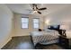 Relaxing bedroom with a ceiling fan, natural light, and dark wood-look flooring at 748 Fast Green Way, Las Vegas, NV 89148