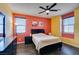 Cozy bedroom with dark furniture, wood-look floors, and colorful wall accents at 748 Fast Green Way, Las Vegas, NV 89148