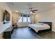 Bright and airy bedroom with wood-look floors, a ceiling fan and large windows that offer plenty of natural light at 748 Fast Green Way, Las Vegas, NV 89148