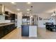 Spacious kitchen featuring dark cabinetry, granite counters, and stainless steel appliances at 748 Fast Green Way, Las Vegas, NV 89148