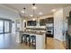 Modern kitchen with dark cabinets, granite countertops, and stainless steel appliances at 748 Fast Green Way, Las Vegas, NV 89148