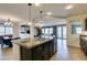 Open concept kitchen with a granite island and seamless connection to living areas at 748 Fast Green Way, Las Vegas, NV 89148