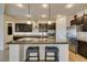 Gourmet kitchen with stainless steel appliances, granite countertops, large island, and pendant lighting at 748 Fast Green Way, Las Vegas, NV 89148