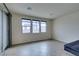 Bright, open living room with tile flooring and sliding glass doors for ample natural light at 748 Fast Green Way, Las Vegas, NV 89148
