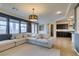 Spacious living room with tile floors, modern lighting, and an open layout to the adjacent kitchen at 748 Fast Green Way, Las Vegas, NV 89148