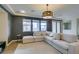 Inviting living room with neutral tones, tile floors, a contemporary light fixture, and large windows at 748 Fast Green Way, Las Vegas, NV 89148