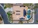 Aerial view of a home with a tile roof with solar panels and a backyard pool with lush landscaping at 7816 Sandy Eagle Ct, Las Vegas, NV 89129