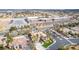 Desert home with a landscaped front yard and palm trees, and a school nearby, as seen from an aerial view at 7816 Sandy Eagle Ct, Las Vegas, NV 89129