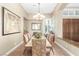 Elegant dining room with tile flooring, shuttered windows, and stylish furnishings at 7816 Sandy Eagle Ct, Las Vegas, NV 89129