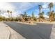 Community entrance showcasing elegant signage, palm trees, and manicured landscaping at 7816 Sandy Eagle Ct, Las Vegas, NV 89129
