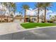 Charming single-story home featuring a three car garage, manicured landscaping, and tall palm trees at 7816 Sandy Eagle Ct, Las Vegas, NV 89129
