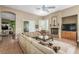 Spacious living area with fireplace, neutral color palette, and access to outdoor spaces at 7816 Sandy Eagle Ct, Las Vegas, NV 89129