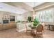 Cozy open-concept living and dining area with fireplace and plantation shutters at 7816 Sandy Eagle Ct, Las Vegas, NV 89129