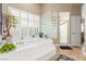Luxurious bathroom with soaking tub, glass block window and walk-in shower at 7816 Sandy Eagle Ct, Las Vegas, NV 89129