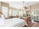 Bright bedroom with decorative wood bed frame, fireplace and bright windows at 7816 Sandy Eagle Ct, Las Vegas, NV 89129