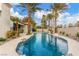 Stunning pool with rock features surrounded by palm trees creating a private oasis at 7816 Sandy Eagle Ct, Las Vegas, NV 89129