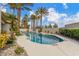The backyard has a pool, waterfall feature, and many palm trees at 7816 Sandy Eagle Ct, Las Vegas, NV 89129