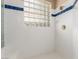 Shower featuring decorative tile, glass block window, and bench seat at 7816 Sandy Eagle Ct, Las Vegas, NV 89129