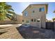 Backyard view showcasing gravel landscaping, two-story home exterior, and perimeter block wall at 7836 Pinnochio Ave, Las Vegas, NV 89131