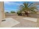 Desert landscaped backyard featuring rock cover, block wall, and two concrete patio areas at 7836 Pinnochio Ave, Las Vegas, NV 89131