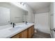 Bathroom featuring a wide mirror, double sinks, and shower over tub at 7836 Pinnochio Ave, Las Vegas, NV 89131