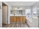 Bright bathroom featuring a double vanity, bathtub and light wood cabinets at 7836 Pinnochio Ave, Las Vegas, NV 89131