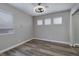 Well-lit bedroom featuring wood-look floors, a window and closet with sliding doors at 7836 Pinnochio Ave, Las Vegas, NV 89131
