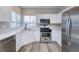 Well-lit kitchen featuring stainless steel appliances, white countertops, and modern cabinetry at 7836 Pinnochio Ave, Las Vegas, NV 89131