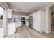 Bright kitchen featuring white cabinets, stainless steel appliances, and sliding glass door to backyard at 7836 Pinnochio Ave, Las Vegas, NV 89131
