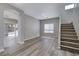 Open-concept living and dining area featuring modern flooring, staircase and natural light at 7836 Pinnochio Ave, Las Vegas, NV 89131