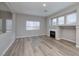 Bright living room featuring a fireplace, large windows, and modern flooring at 7836 Pinnochio Ave, Las Vegas, NV 89131