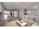 Large living room with open kitchen concept, hardwood floors, and bright neutral walls at 7836 Pinnochio Ave, Las Vegas, NV 89131