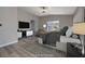 Comfortable main bedroom with a large window, a TV, and contemporary decor at 7836 Pinnochio Ave, Las Vegas, NV 89131