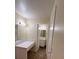 Bright bathroom with a vanity, mirror, and a door leading to the toilet and shower area at 8009 Draco Cir # 201, Las Vegas, NV 89128