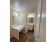 Bright bathroom with a vanity, mirror, and a door leading to the toilet and shower area at 8009 Draco Cir # 201, Las Vegas, NV 89128