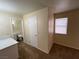 Bright bedroom features neutral walls, carpet flooring, a large window and an ensuite bathroom at 8009 Draco Cir # 201, Las Vegas, NV 89128