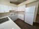 Functional kitchen with white cabinets, appliances, and countertops offers ample workspace at 8009 Draco Cir # 201, Las Vegas, NV 89128