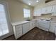 Well-lit kitchen features white cabinets, modern appliances, and durable countertops at 8009 Draco Cir # 201, Las Vegas, NV 89128