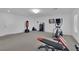 Finished basement features an elliptical and bench press for exercise area at 8178 Eaton Hill St, Las Vegas, NV 89113