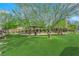 Inviting community park featuring a covered gazebo surrounded by lush green lawns and mature shade trees at 8178 Eaton Hill St, Las Vegas, NV 89113