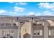 Modern townhome exterior showcases a roof deck with mountain views and neutral stucco, under a beautiful sky at 8178 Eaton Hill St, Las Vegas, NV 89113