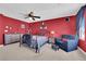 This bedroom features a ceiling fan, carpet floors, and a sitting area at 8178 Eaton Hill St, Las Vegas, NV 89113